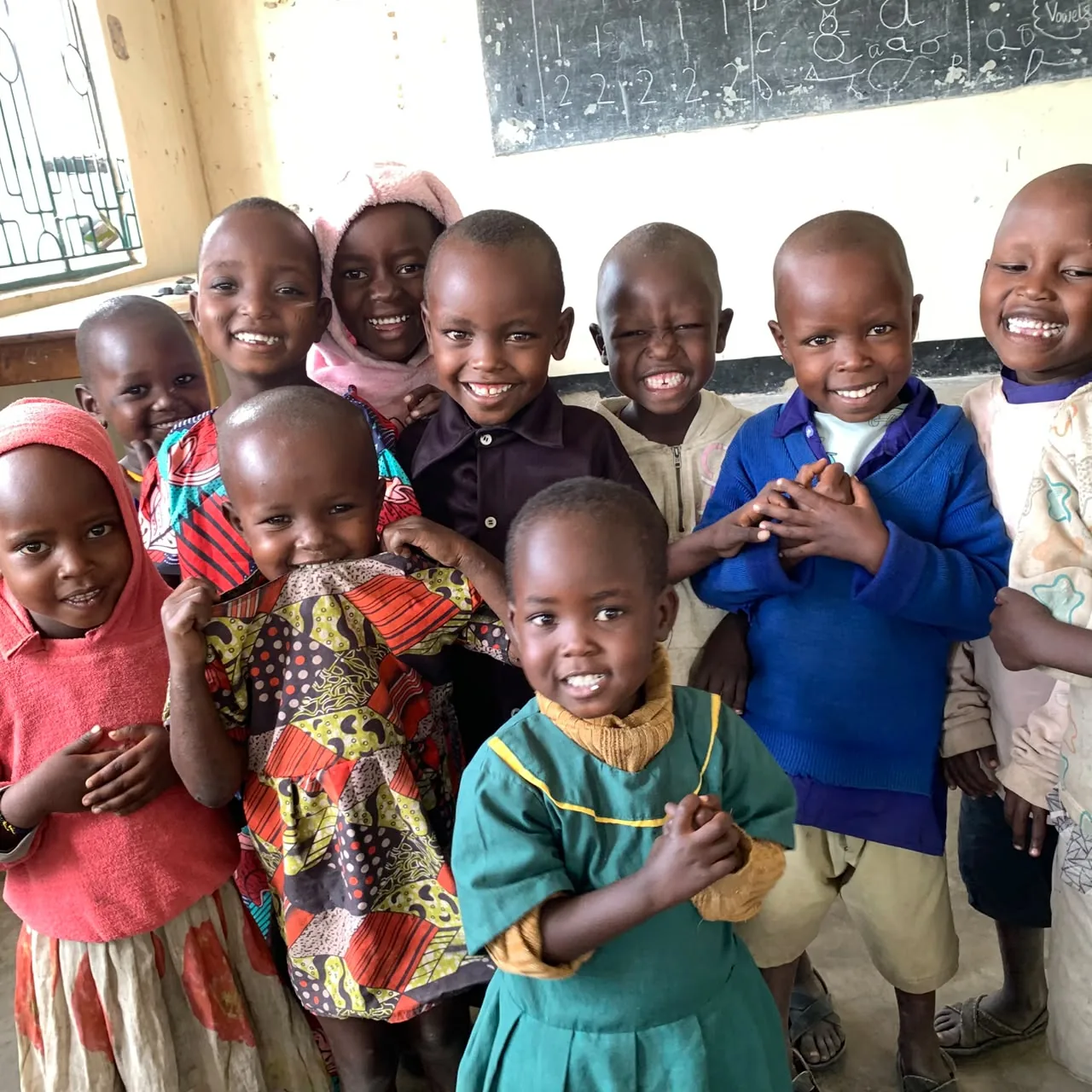 Children smiling classroom blackboard